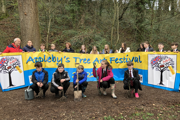 Appleby Grammer School students planting Hazel saplings in Holme wood for Appleby Tree Art Festival
