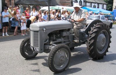 Main riding a tractor through Appleby